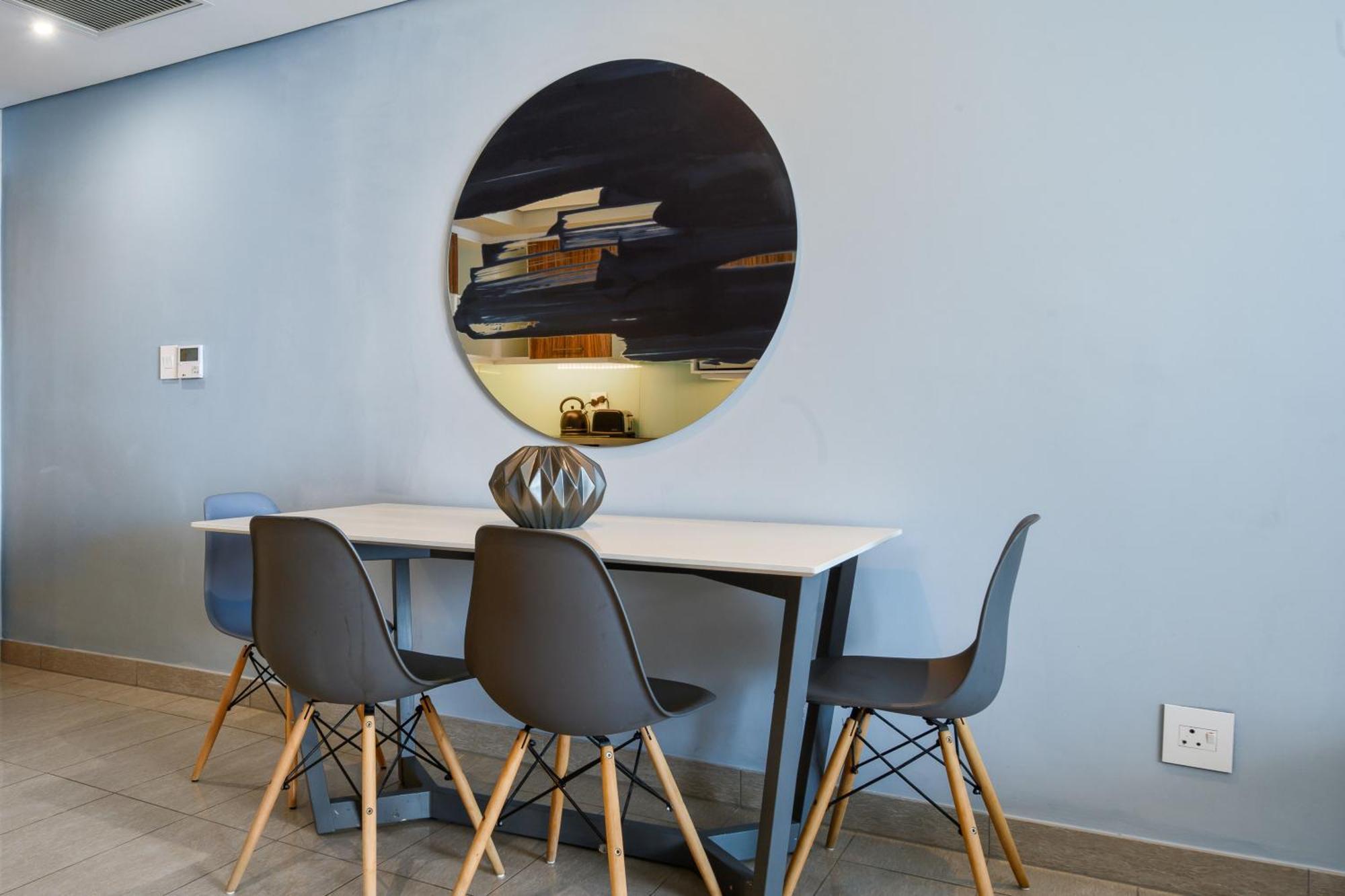 The Capital Pearls Hotel Durban Exterior photo A dining room with a table and chairs